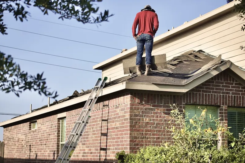 Professional roofer working on a residential roof in American Beauty Gardenhomes